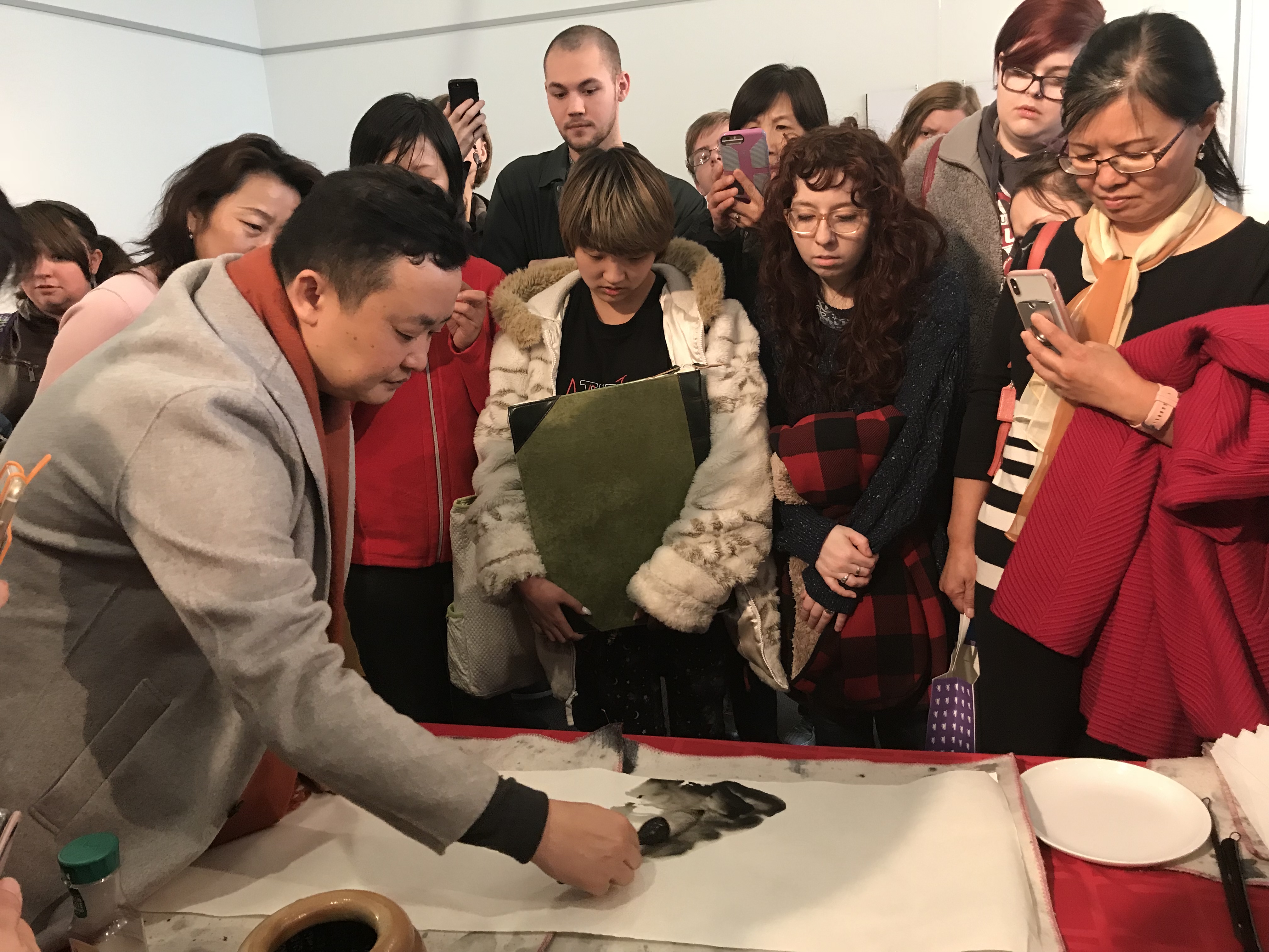 Artist Lin Dihuan doing a live painting demonstration